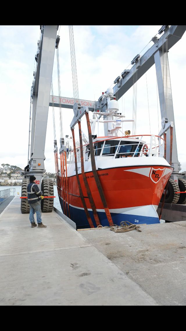 Trawler being launched by crane