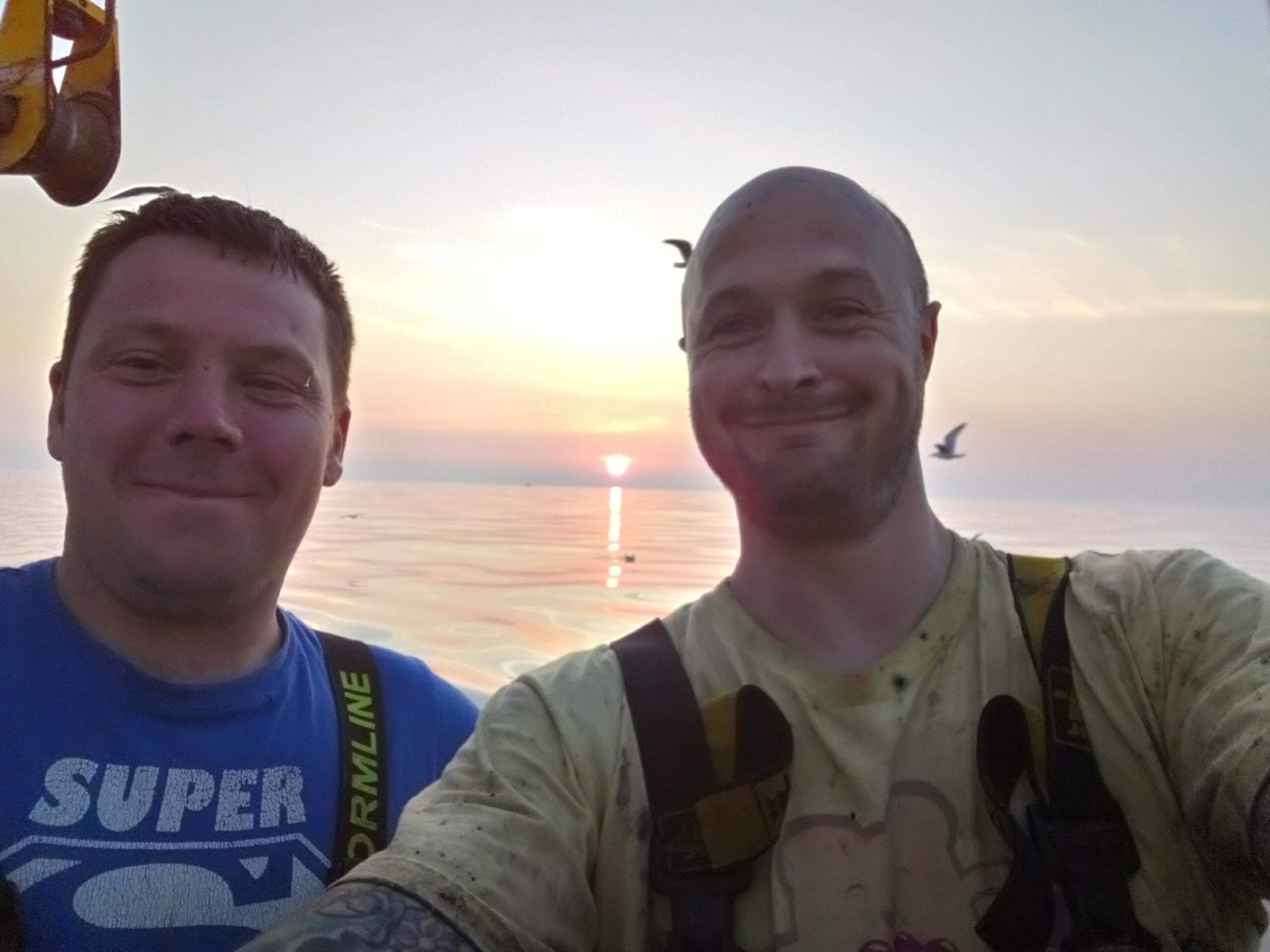 Two crew at sunrise on the water