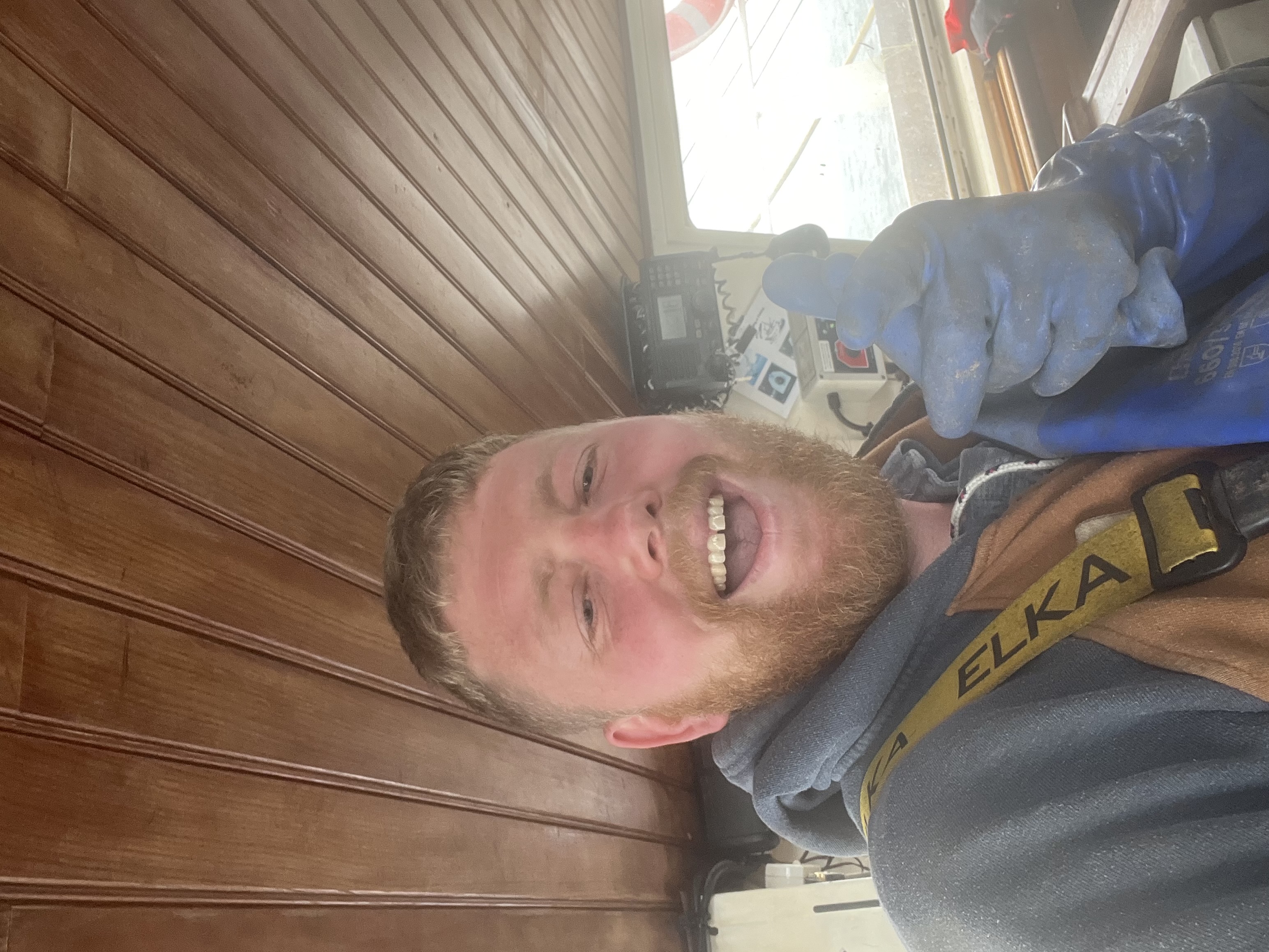 Happy skipper in the wheelhouse — thumbs up