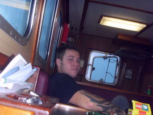 Young skipper relaxing in the wheelhouse