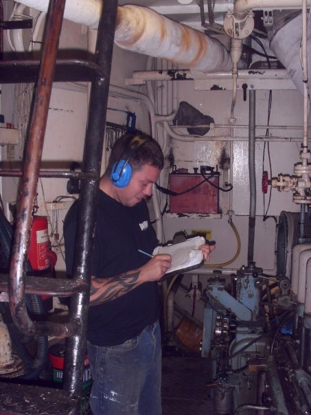 Engineer checking logs in the engine room