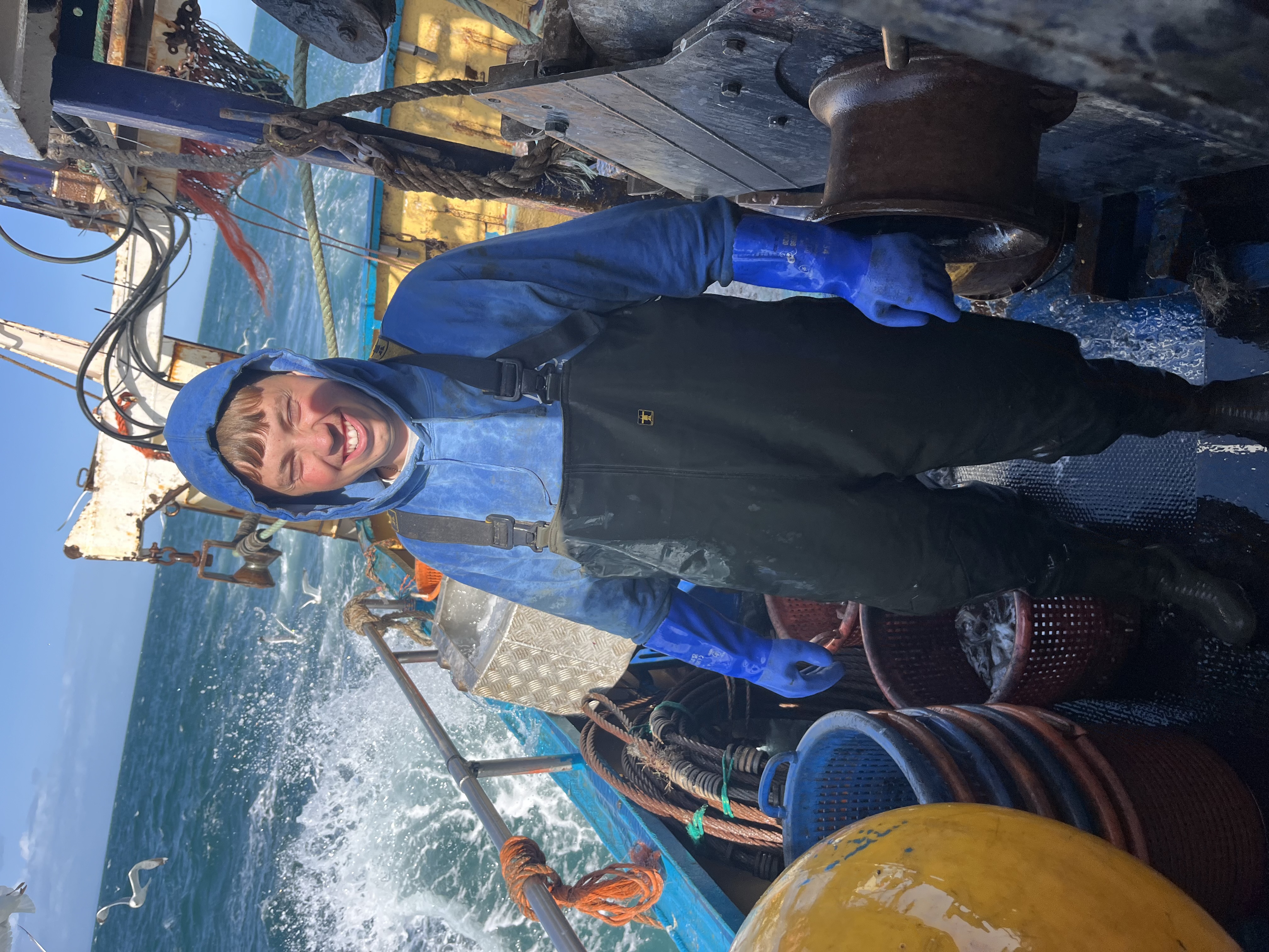 Young crew member smiling on deck
