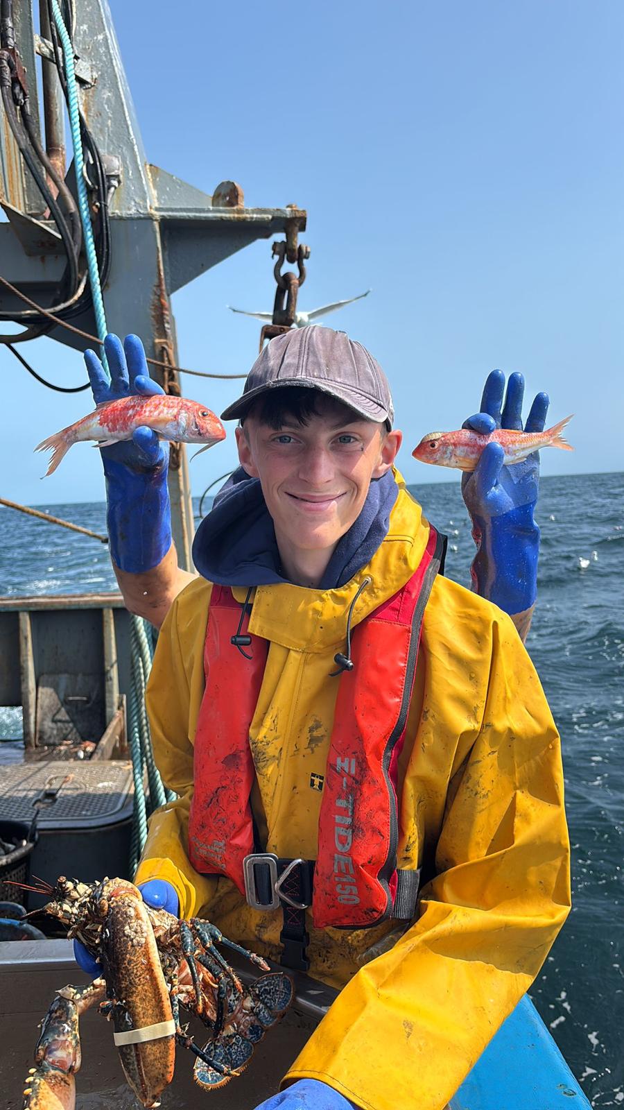 Crew member holding a red gurnard pair